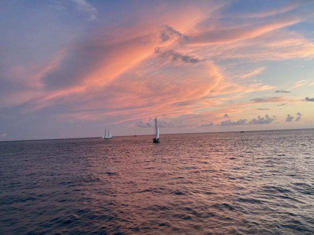 sailboat on a calm ocean at sunset